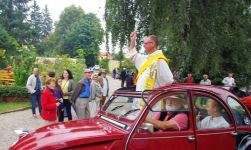 Hans Aumayr fährt mit Diakon Andreas Hagler und Ministranten bei der Fahrzeugsegnung im „Papamobil“ Citroen 2  CV; Bild: Judith Skopec